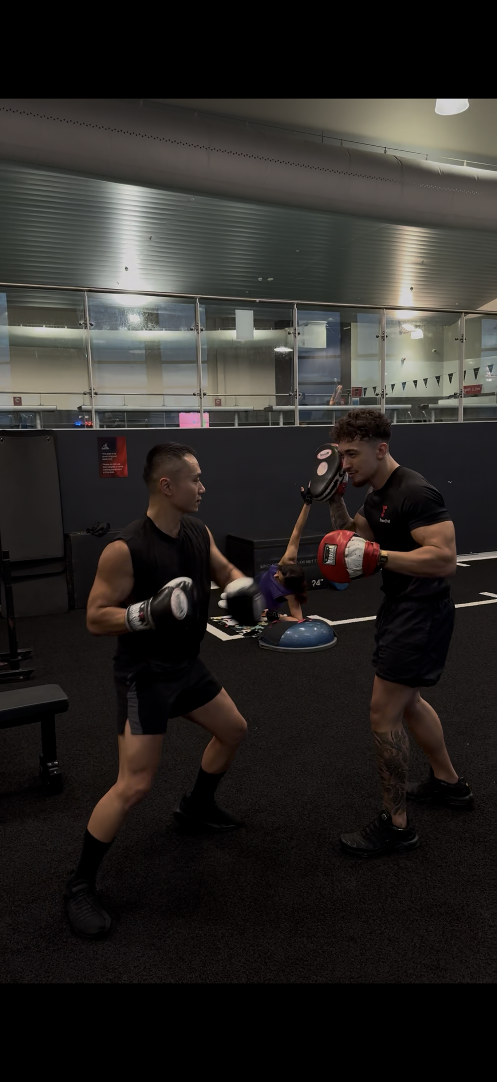 Ethen holding pads for a client boxing session