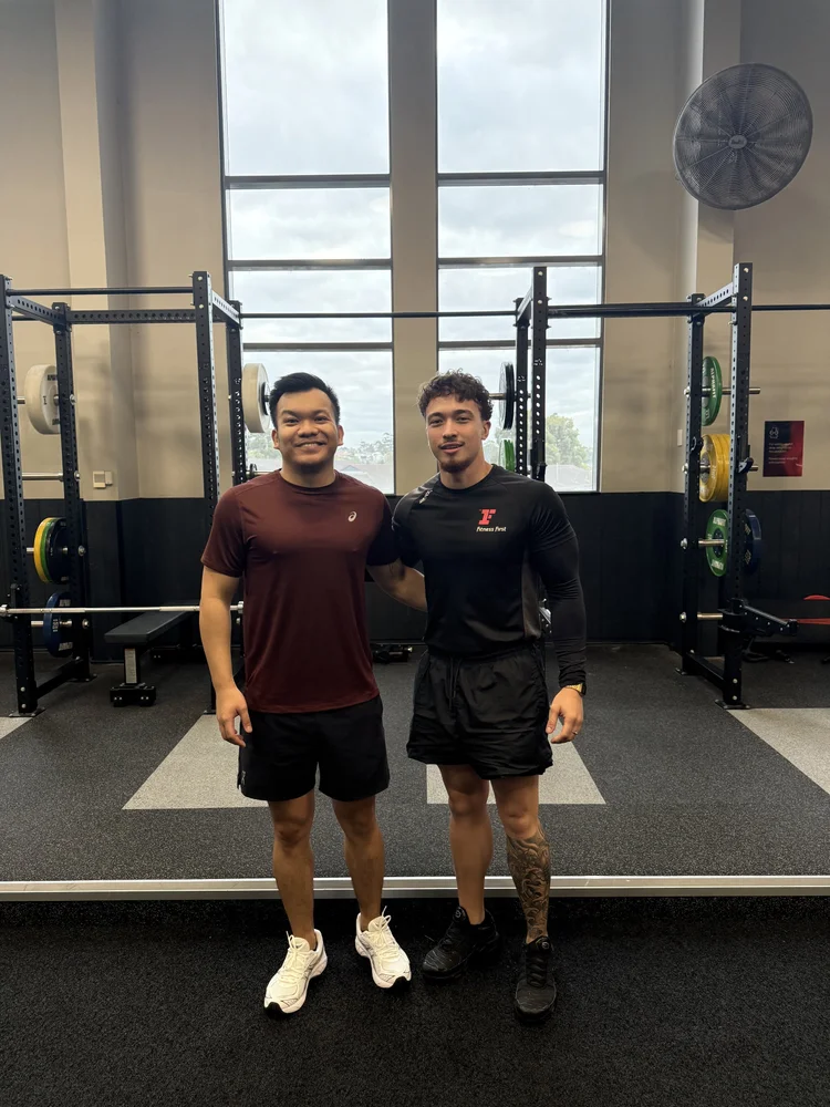 Ethen and a client in front of the squat racks